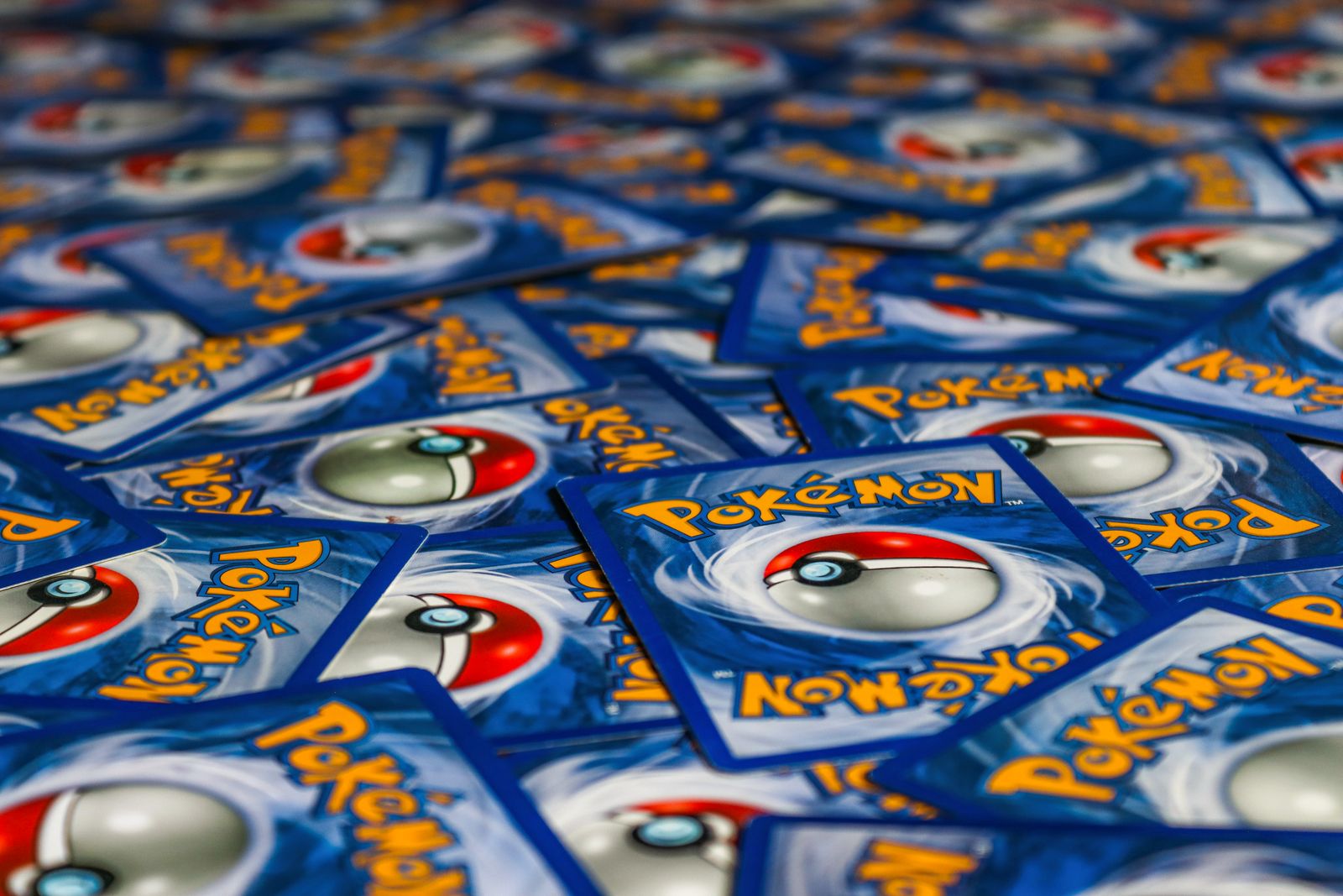 Pokémon cards spread face down, seen from a low angle